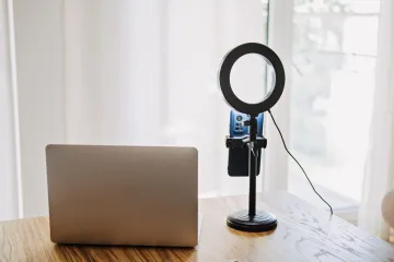 Personal computer, light ring and stand with phone holder to record video and video-streaming at home.