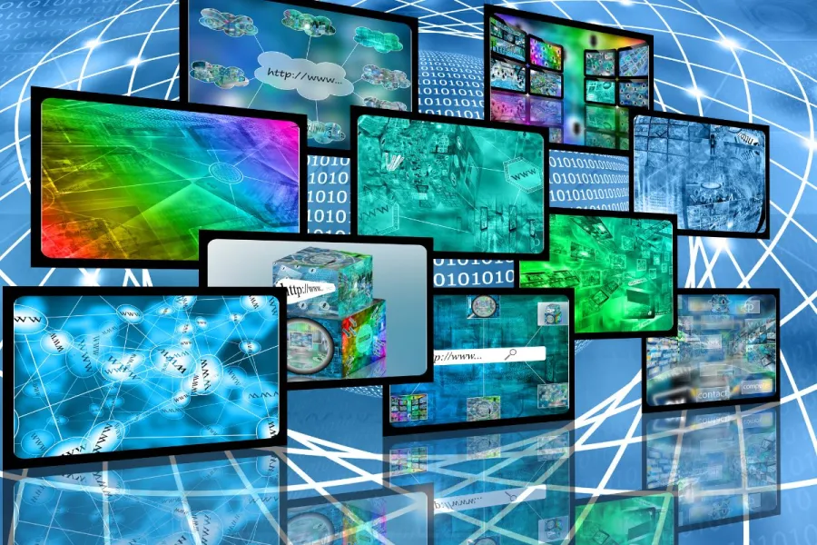 Several computer screens with web content.